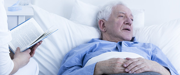 nurse-reading-to-elderly-patient-2021-08-26-15-43-47-utc